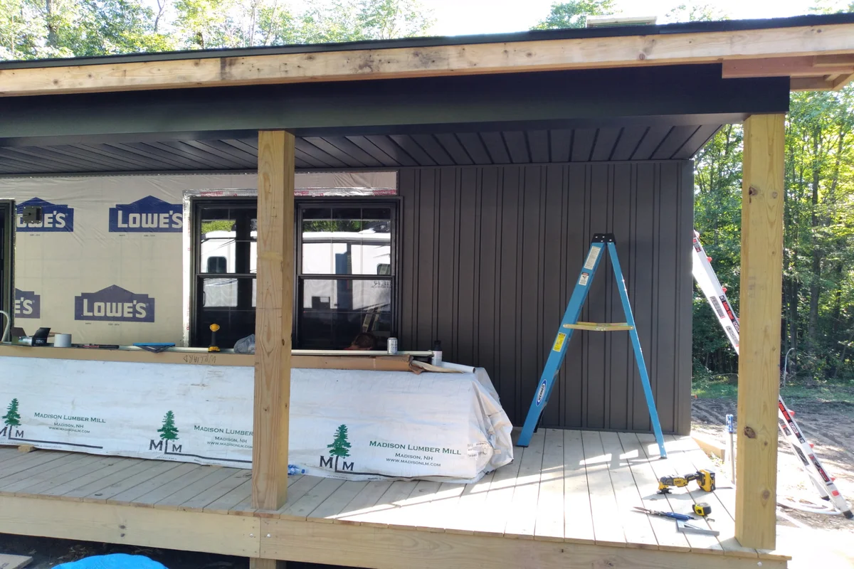 Detail of new siding installation in progress on the cabin