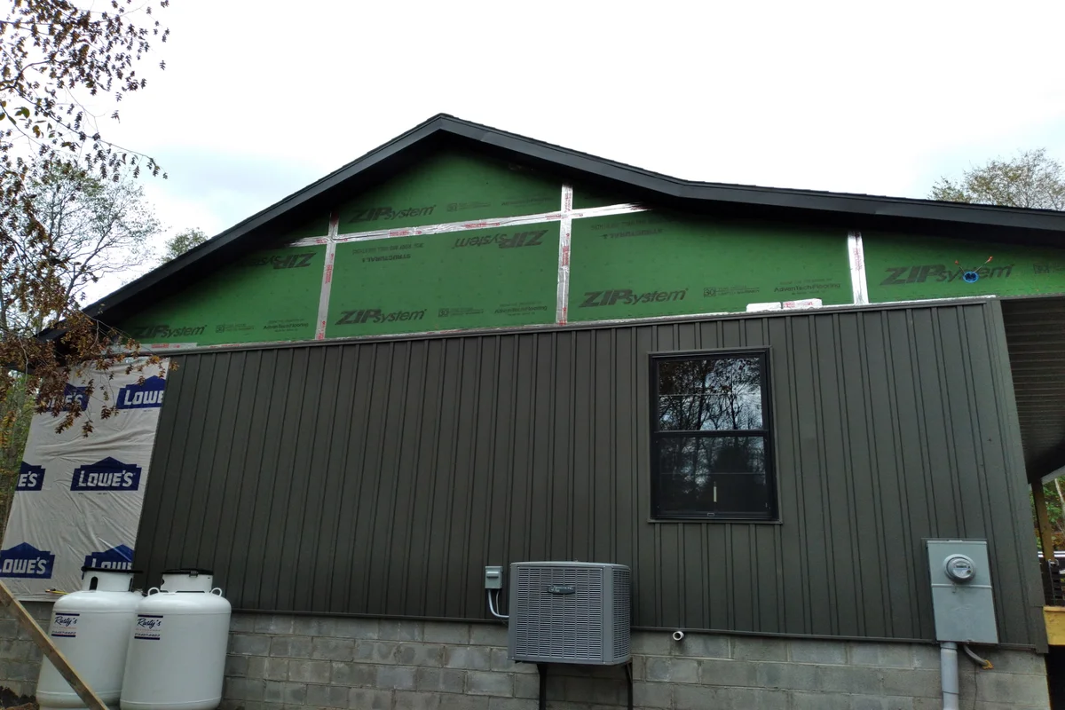 Side angle of the cabin showcasing the new siding and trim work