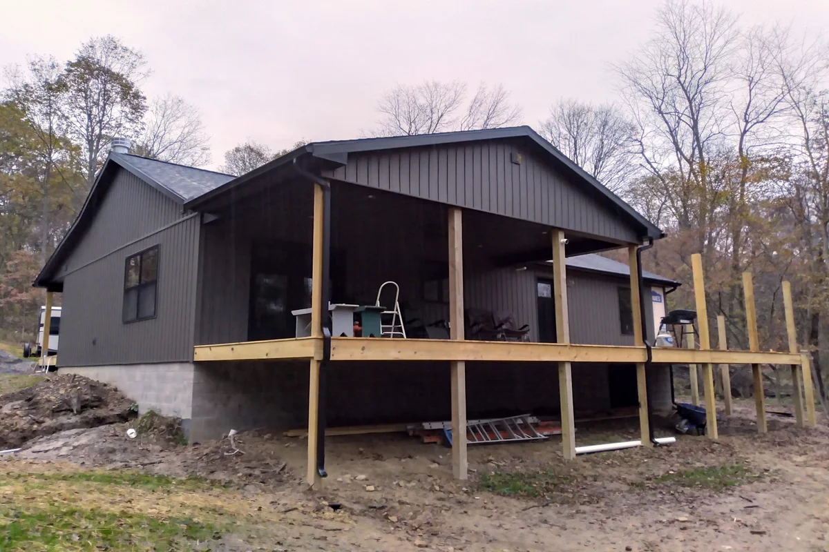 After: Completed cabin with new siding, windows, and trim