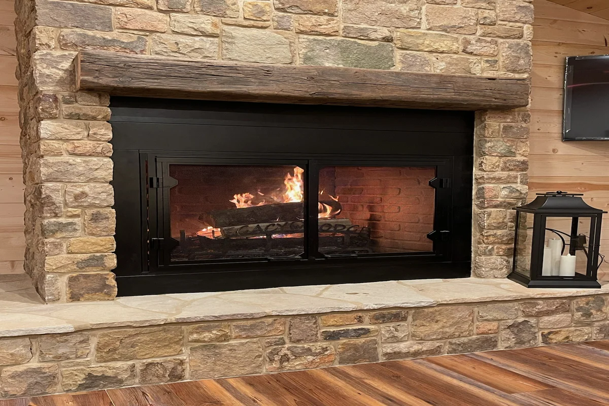 Completed fireplace with custom stone surround and mantel