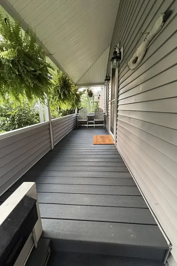 After: Fully repaired and resurfaced porch with new woodwork.