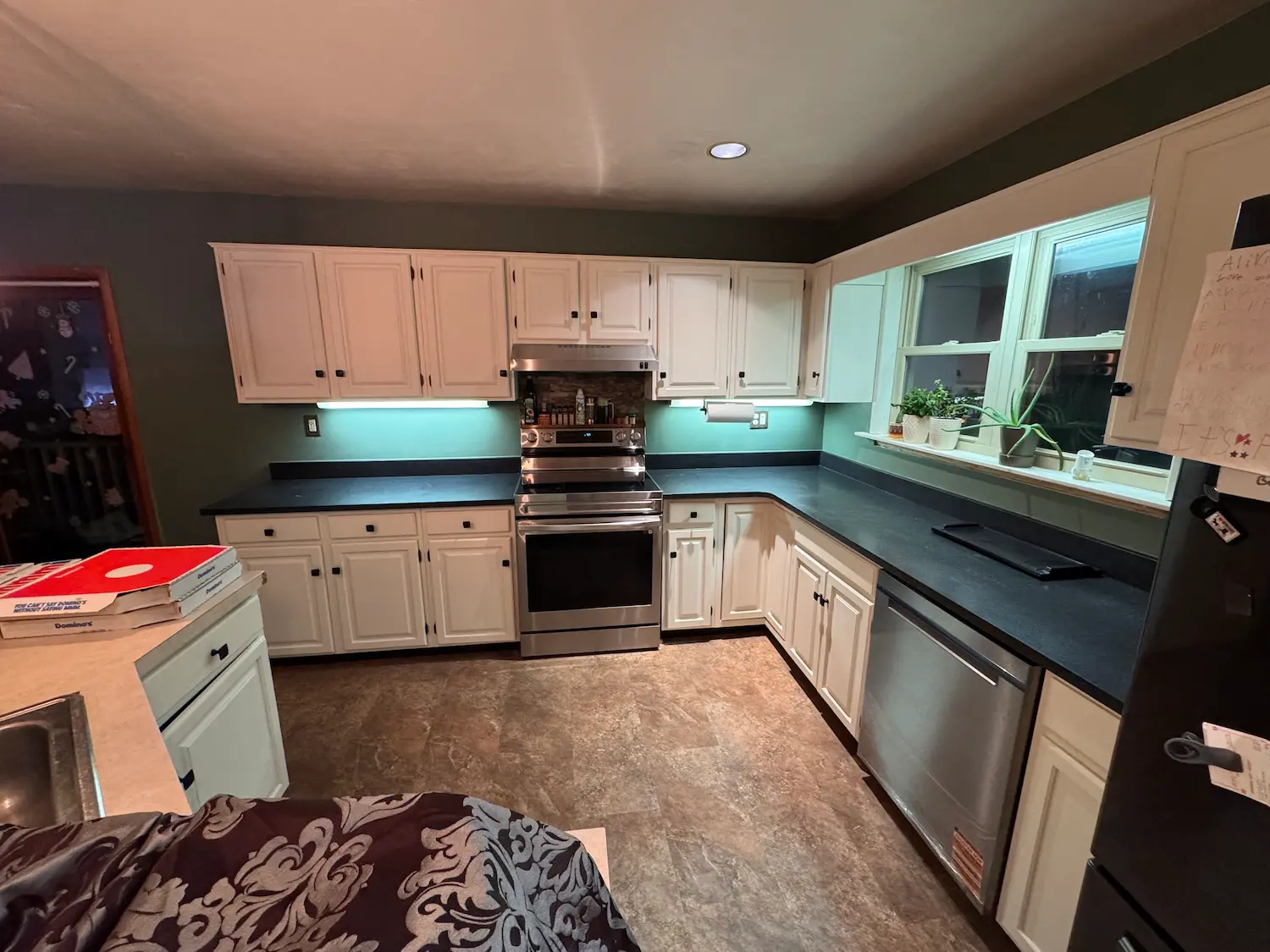After: Modern kitchen with refinished cabinets and new island