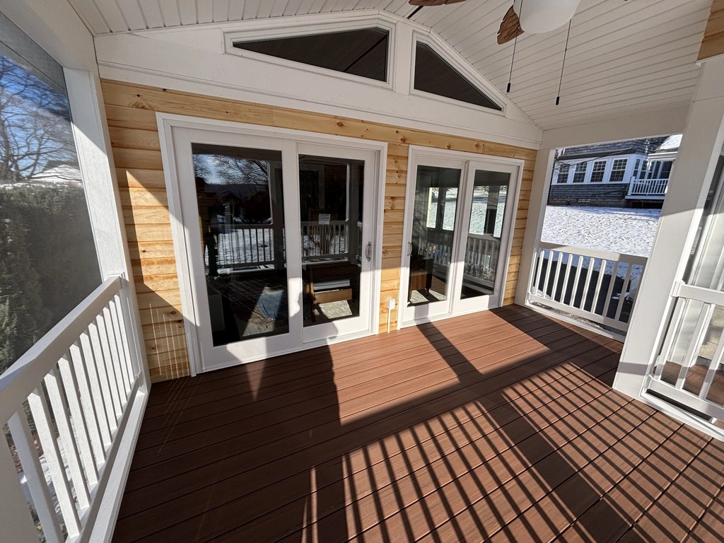 After: Finished stick-build porch with custom wood ceiling and composite deck