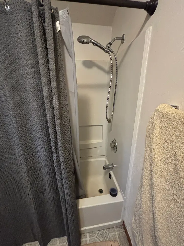 Before: Outdated bathtub and shower surround